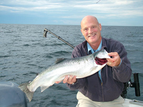 Tom with Steelhead - Leprechaun Fishing Charters on Lake Michigan