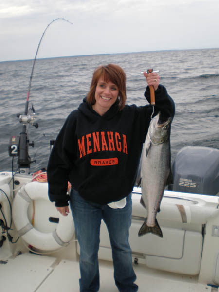 Jennifer holding up her first king salmon - Leprechaun Fishing Charters on Lake Michigan