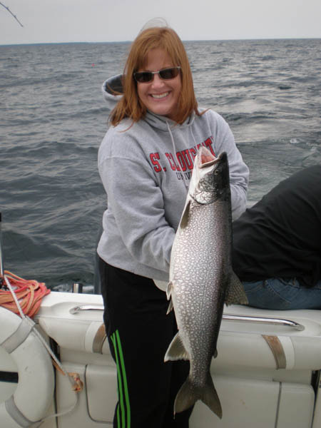 Kristin and the first Lake Trout of the season - Leprechaun Fishing Charters on Lake Michigan